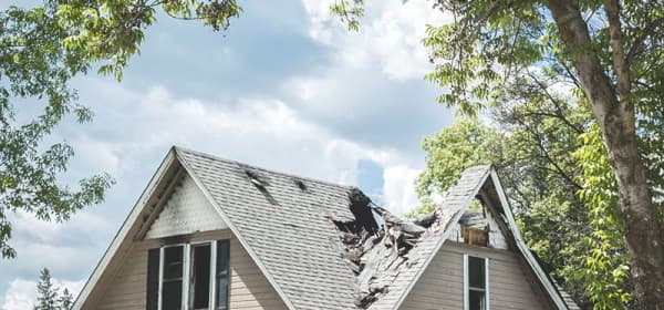 Haus mit schweren Sturmschäden braucht dringend eine Dachreparatur von Aroundhome
