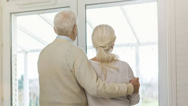 Älteres Ehepaar schaut aus dem Fenster