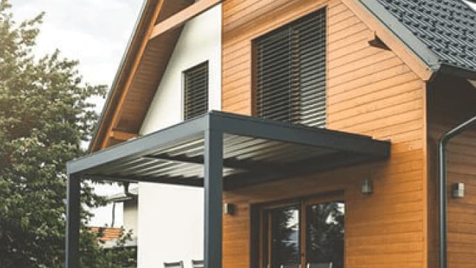 Banner - Haus mit Materialmix aus Holz und Putz mit schwarzem Dach und Terrassenüberdachung