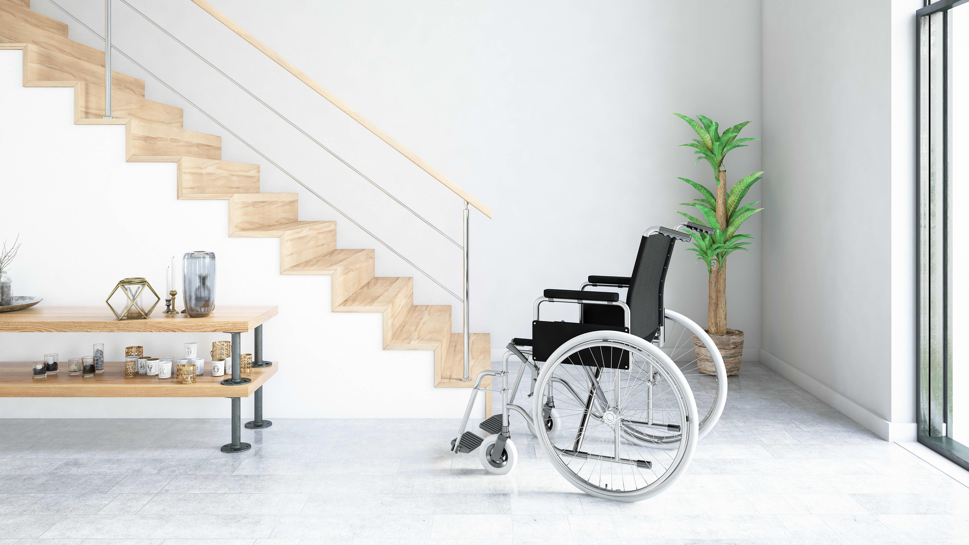 Rollstuhl in hellem, modernem Raum vor einer Treppe mit Holzstufen und bodentiefen Fenstern