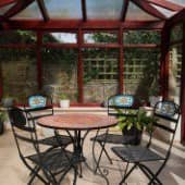 Wintergarten mit einem Tisch und Stühlen