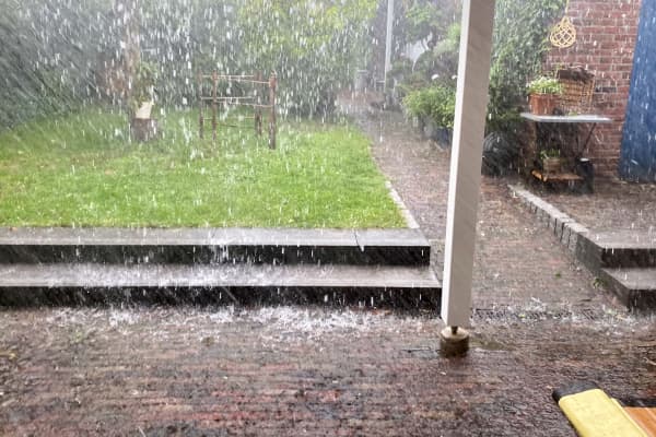 Starker Regen mit viel Wasser auf einer Terrasse