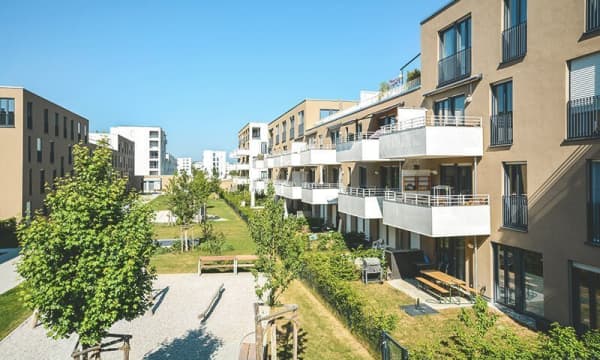 Neubaugegend mit Wohnungen und grünem Innenhof