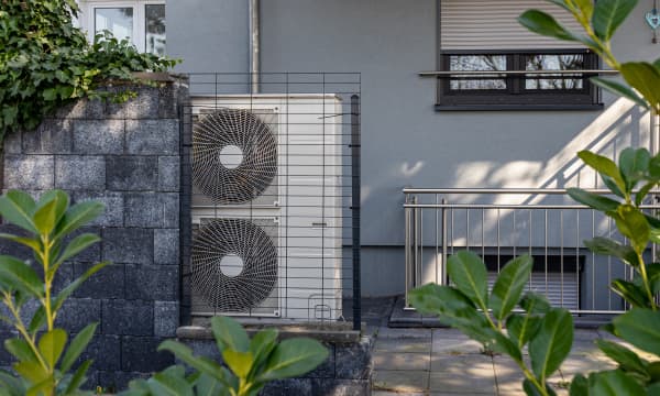 Wärmepumpe vor einem modernen Haus