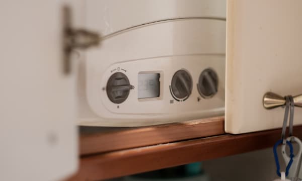 Gas Boiler hinter offener Tür im Haus