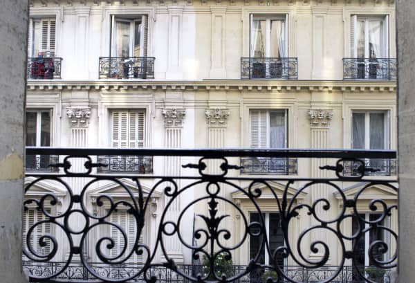 Blick auf historische Hausfassade mit französischem Fenstergitter