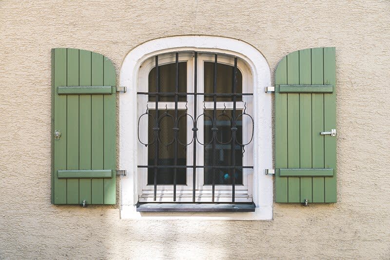 Fenster mit Fenstergitter und Fensterläden