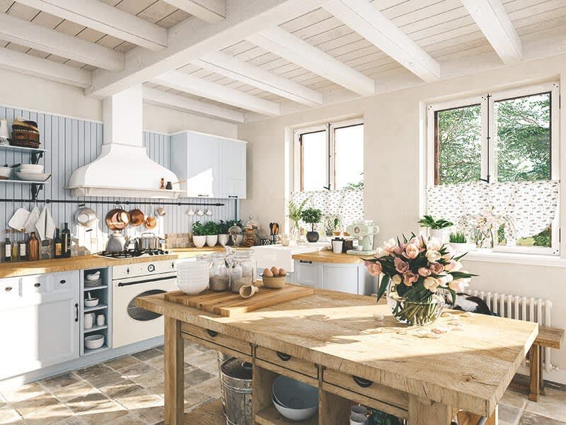 Weiße Küche mit Holztisch in der Mitte