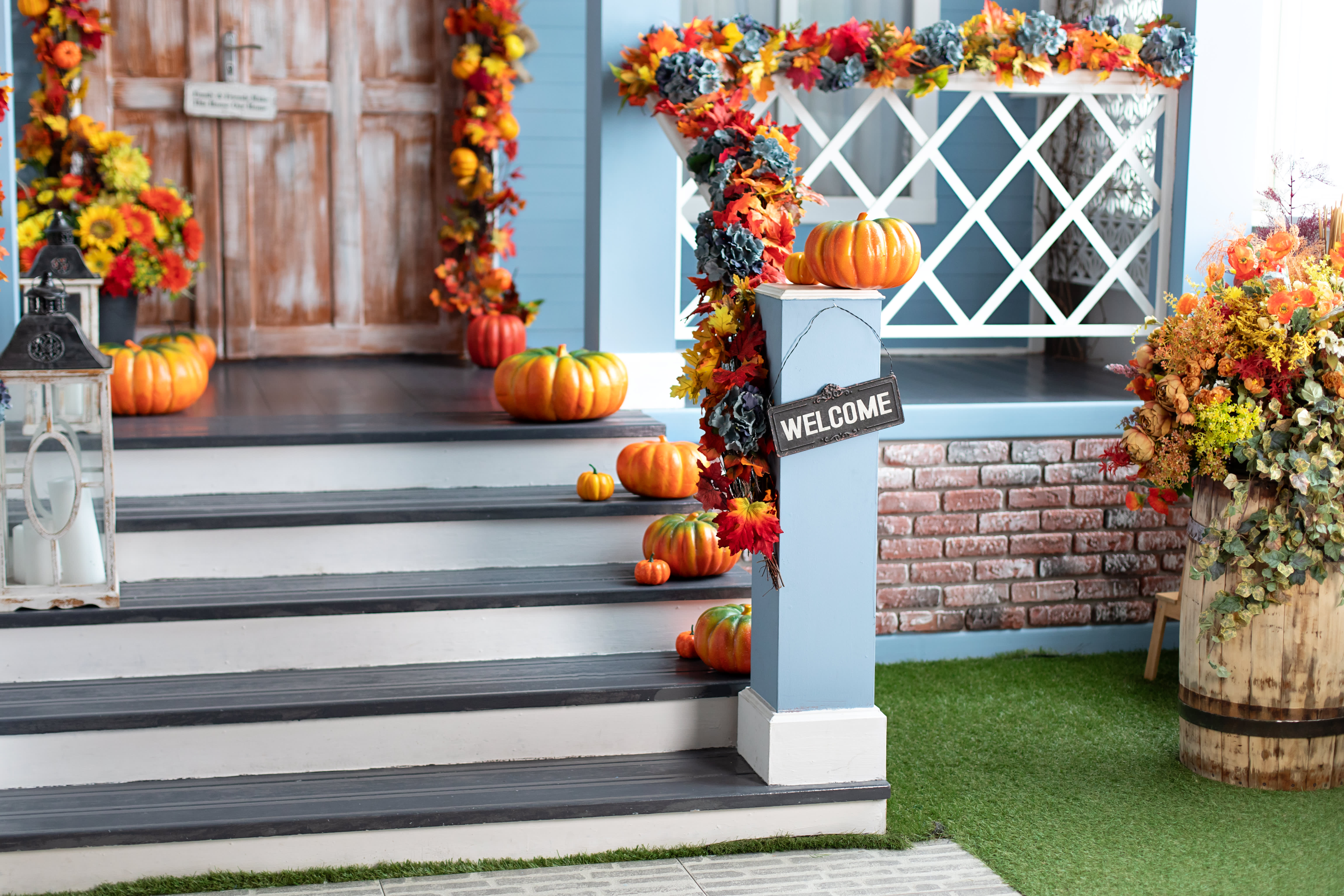 Wohnhaus mit hellblauer Fassade ist herbstlich geschmückt