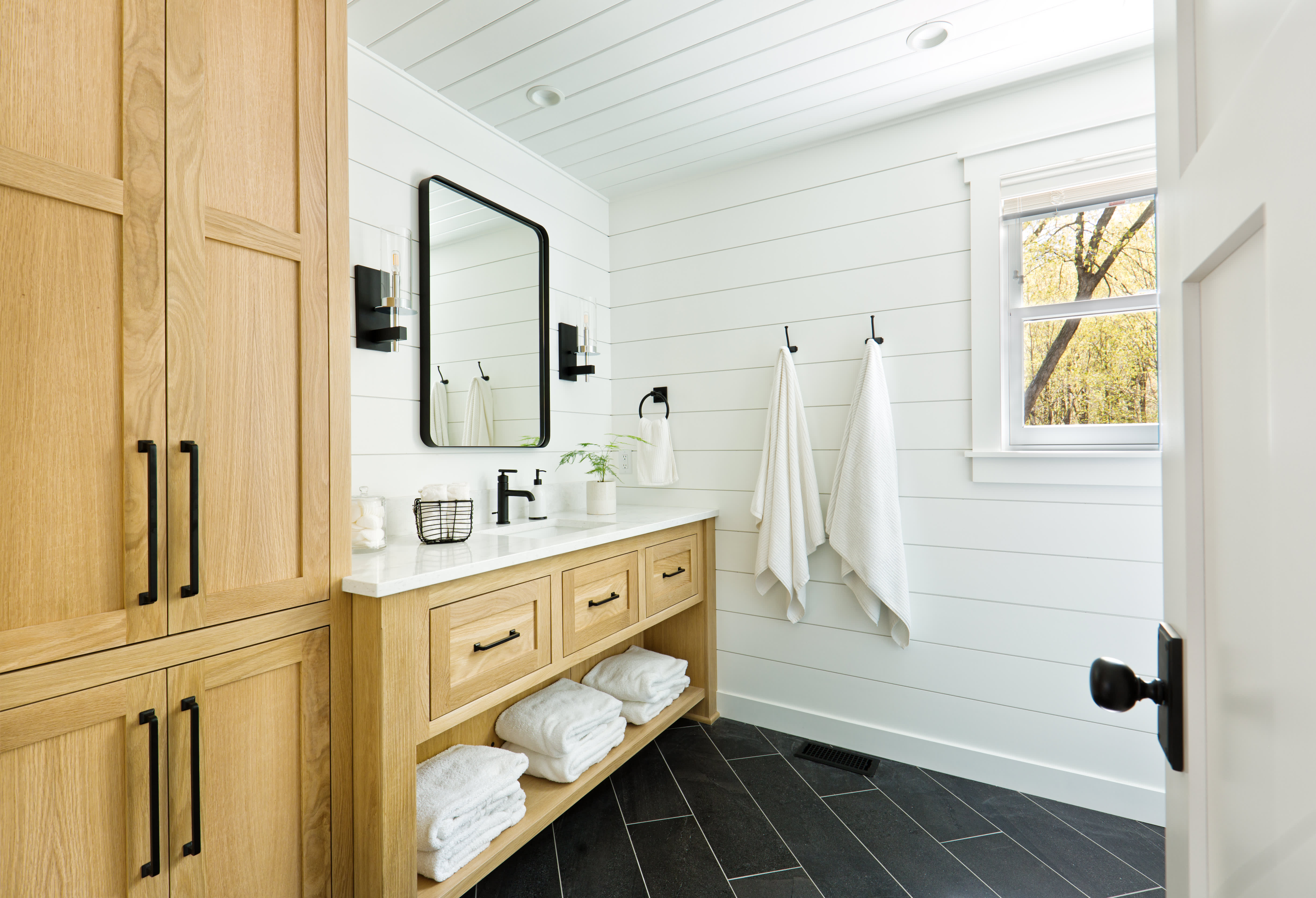 Badezimmer mit Waschtisch aus Holz.